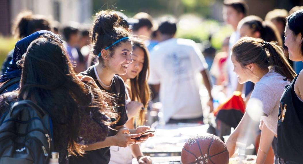 students learn about clubs and organizations at club fair